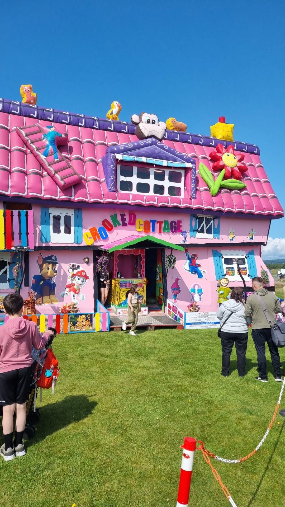 The colourful Dorwards Crooked Cottage funhouse at a daytime event